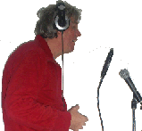 a photograph of Greg speaking into a microphone